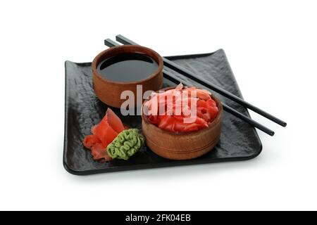 Plate with pickled ginger, soy sauce, chopsticks and wasabi isolated on white background Stock Photo