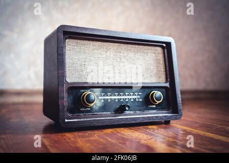 Retro radio. Old vintage music player in 60s style. Dusty receiver, speaker and boombox. Technology nostalgia. Knobs and frequency tuner.