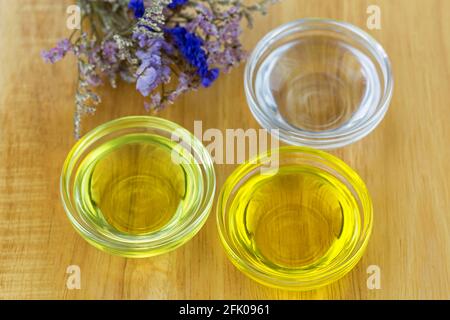 Bowl of different organic oil - cold pressed Coconut oil, Jojoba Oil, Caster oil to make homemade skin beauty product Stock Photo