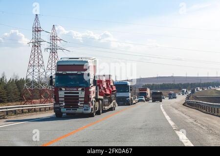 Interstate Highway Ufa - Kazan M7, Russia - Apr 23th 2021. Scania truck transports special tracked equipment for fire extinguishing. Truck move along Stock Photo