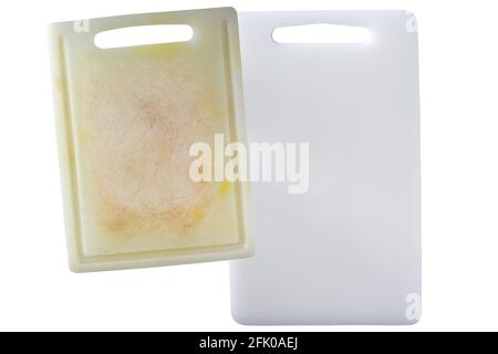 New clean and dirty white plastic cutting board with dark stains scratch isolated on white background Stock Photo