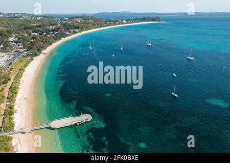 Aerial view of Shoal Bay foreshore and wharf looking west over the aqua waters of Port Stephens, Australia. Stock Photo