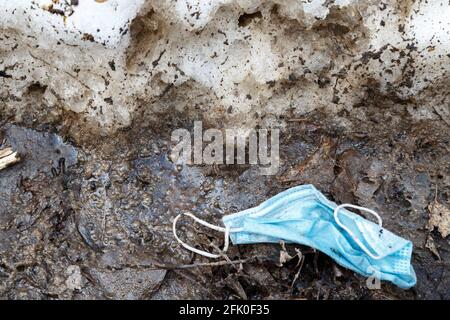 Image of throwed used medical mask on the ground Stock Photo