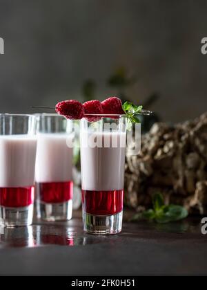 Shot cocktails with raspberry, vanilla liqour, vodka. Fresh summer shots for party. Alcohol shots Stock Photo