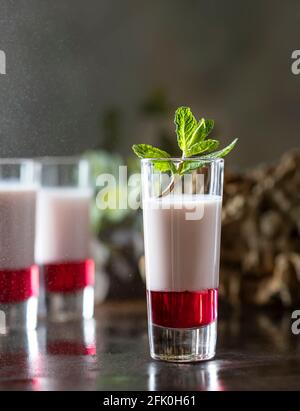 Shot cocktails with raspberry, vanilla liqour, vodka. Fresh summer shots for party. Alcohol shots Stock Photo