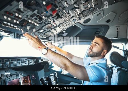 Making final preparations in the flight deck of passenger aircraft Stock Photo