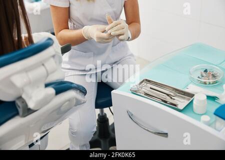 Orthodontist using dental putty to make teeth impressions of a