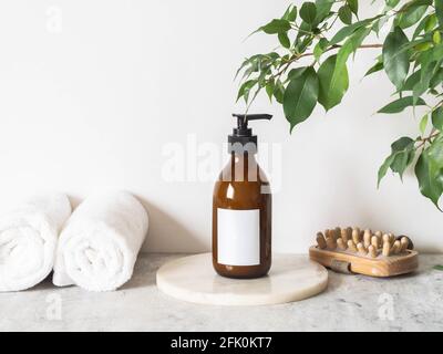 Brown glass bottle mockup for cosmetic products, cotton towels and wood massager. Front view. copy space. cosmetics product mock up. Blogging minimal Stock Photo