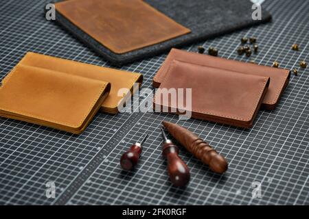 Handmade products made of genuine yellow and red leather. Leather passport cover, leather wallet. Leather goods for men. The view from the top. Stock Photo