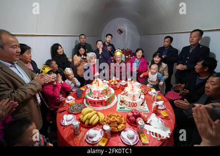 (210427) -- TAIYUAN, April 27, 2021 (Xinhua) -- Hu Zaizhong hears family members singing birthday song at his birthday banquet at Xuejiawan Village, Liulin County, Lyuliang City of north China's Shanxi Province, on April 24, 2021. Hu Zaizhong, who has just turned 100, vividly remembers his wishes at different stages of his life: having decent food and clothing in his early days, teaching as many pupils as he could in his prime age, and enjoying quality time with his family for late years. Nonetheless, Hu made a new wish before blowing the candles on his birthday cake. All members of Hu's exten Stock Photo