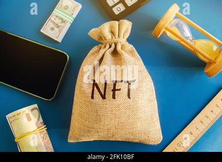 Money bag NFT - non-fungible token. Digitally represented product or asset. Selling digital assets and art through auctions. Blockchain technology. Mo Stock Photo