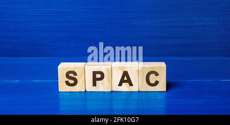 Wooden blocks with the word SPAC - Special purpose acquisition company. Simplified listing of company, merger bypassing stock exchange IPO. Assessment Stock Photo