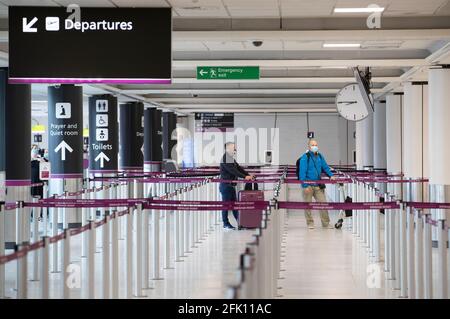File photo dated 15/06/20 of passengers, wearing a protective face masks, waiting at the check-in area at Edinburgh Airport. Fewer members of the public anticipate using buses, trains and planes after Scotland has emerged from lockdown, according to new research. Issue date: Tuesday April 27, 2021. Stock Photo