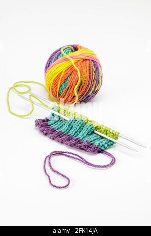 Multi coloured wool with knitting isolated on white background Stock Photo
