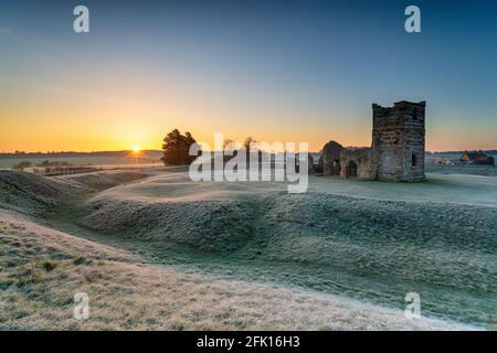 Frosty sunrise over the old church at Knowlton near Wimborne in the Dorset countryside Stock Photo