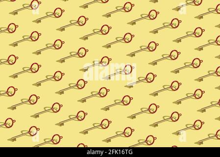 Creative seamless wallpaper with vintage key arranged in the pattern on a yellow background. Isometric layout. Abstract concept Stock Photo