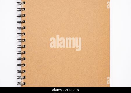 Close up, top view of brown color blank paper cover spiral notebook, copy space for your text. Stock Photo
