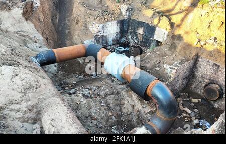 Underground large gas pipe line and valve fixed in trench Stock Photo