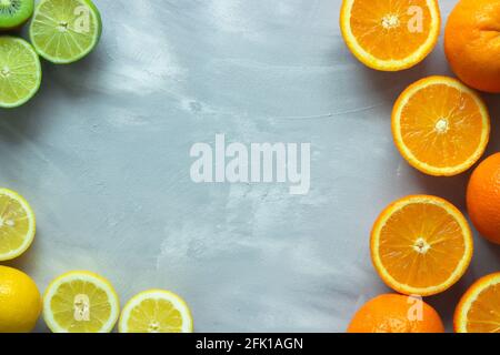 Colorful and tropical citrus fruits on gray background with copy space Stock Photo