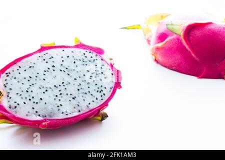 Bright pink dragon fruit cut in halves on gray textured background Stock Photo
