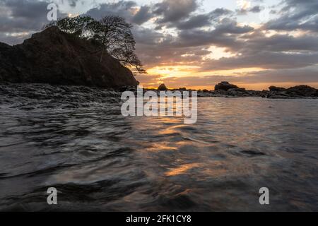 PANAMA, PANAMA - Apr 25, 2021: Beautiful sunset on the beach on a high tid Stock Photo