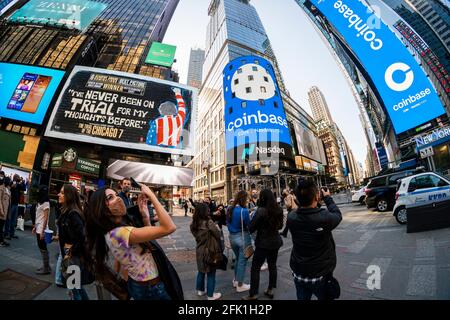 Workers and supporters outside the giant video screen on the Nasdaq stock exchange in Times Square in New York decorated for the debut of the Coinbase direct listing on Wednesday, April 14, 2021. Coinbase is the first cryptocurrency exchange to trade publicly. (© Richard B. Levine) Stock Photo