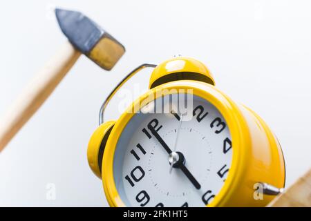 Hammer Smashing Alarm Clock At 6 O'Clock In The Morning Stock Photo