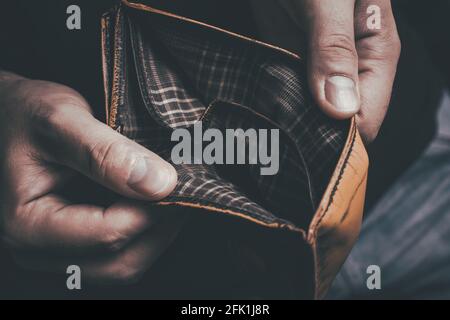 Man Showing His Empty Wallet - No Money Left Concept Stock Photo