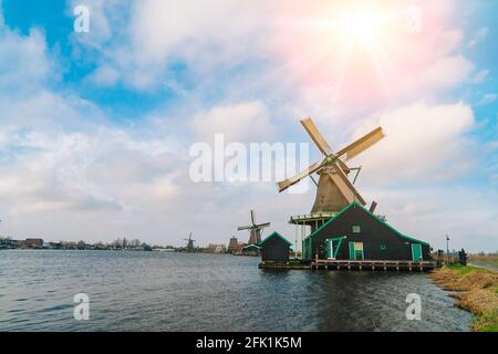 Beautiful tradition dutch scenery panorama of Zaanse Schans windmill village in Netherlands. Authentic Zaandam mills on the water channel in Zaanstad village. Typical holland postcard view . selective focus Stock Photo