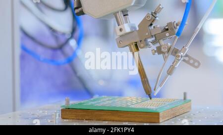 Process of selective soldering components to printed circuit board at factory Stock Photo