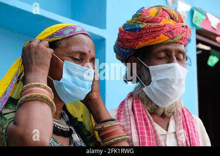 Elderly Indian couple in traditional clothes wearing protective masks Stock Photo
