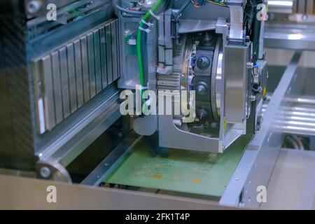 Automatic SMD pick and place machine assembling computer circuit board Stock Photo