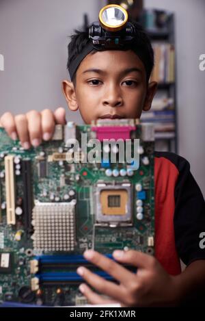Student boy Studying and repairing Pc motherboard in the Computer Lab ...