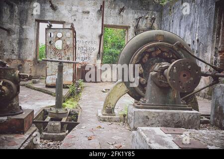 Old and abandoned factory that still has very old machinery, old structures that are in the middle of the forest Stock Photo
