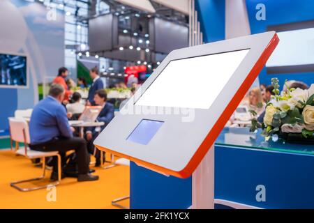 Electronic multimedia tablet kiosk with blank white display at exhibition Stock Photo