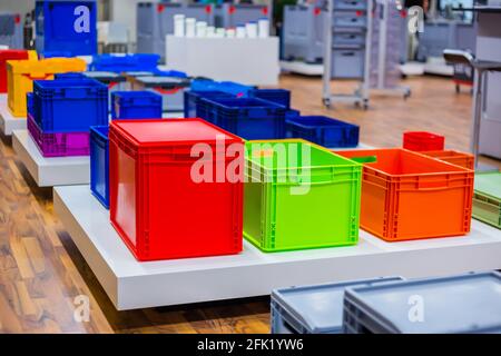 Many colorful plastic boxes, containers, crates at storage exhibition Stock Photo