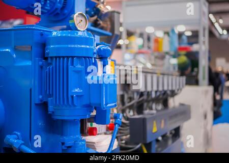 Part of automatic injection molding machine at plastic exhibition Stock Photo
