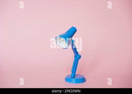 Closeup of mini blue  modern desk lamps on pink background Stock Photo
