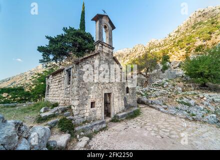 Standing next to walls of the San Giovanni Fortress this 1000 year old small,disused historic church, is set amongst beautiful stunning mountain scene Stock Photo
