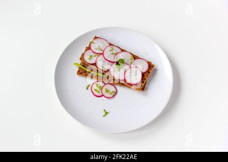 Bread rolls with chopped radishes and herbs. Sandwich with vegetables and basil. Stock Photo