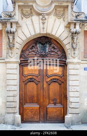 Ornate wooden doors in the Marais, Paris, Ile-de-France, France Stock Photo