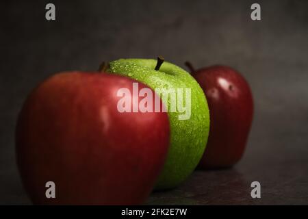 three apples on a dark background Stock Photo