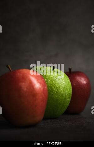 three apples on a dark background Stock Photo
