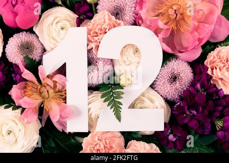 Layout with colorful flowers, leaves and number twelve. Chrysanthemum Momoko, Peony, Matthiola, Ranunculus flowers background. Greeting card. Trendy b Stock Photo