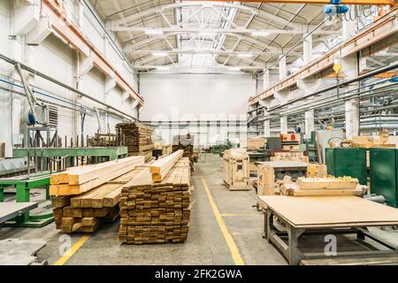 Inside huge factory workshop interior with stacks of wood for making molds. Stock Photo