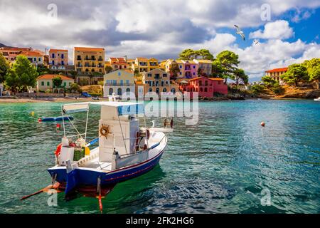 Turquoise colored bay in Mediterranean sea with beautiful colorful houses in Assos village in Kefalonia, Greece. Town of Assos with colorful houses on Stock Photo