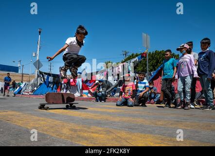 Tijuana, Mexico. 6th Apr, 2021. Migrant children gather to play with roller blades and skateboards in El Chaparral plaza on Mexican side of the San Ysidro Port of Entry. Credit: Raquel Natalicchio/ZUMA Wire/Alamy Live News Stock Photo