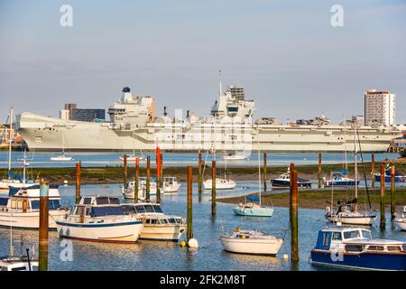 View of the Royal Navy Flagship HMS Queen Elizabeth (R08) in Portsmouth Naval Base, UK on the 27th April 2021 after embarking anti submarine and airborne early warning variants of the Merlin helicopter. The ship is making final preparations for Carrier Strike Group exercises in UK waters and then deployment overseas. Stock Photo