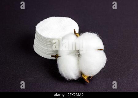 White soft cotton pads for hygiene and healthcare on black background. Stock Photo