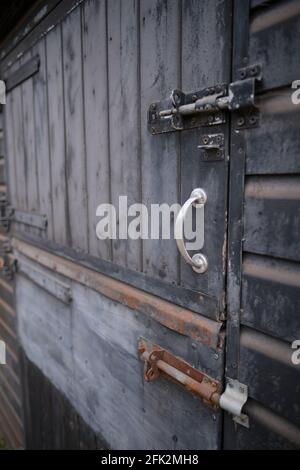 Perspective view of old rusty metal door with locks. Focused in foreground. Stock Photo